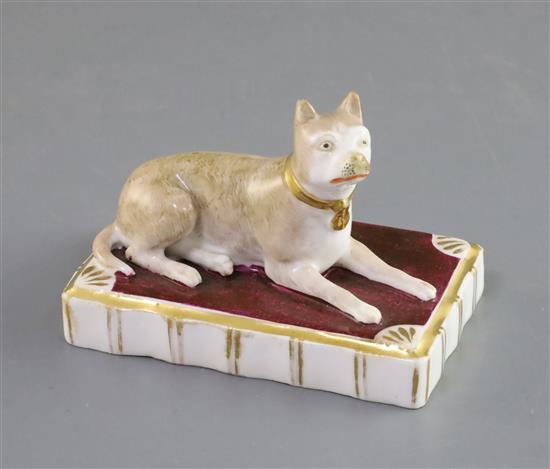 A Rockingham porcelain figure of a recumbent terrier, c.1830, L. 9.7cm